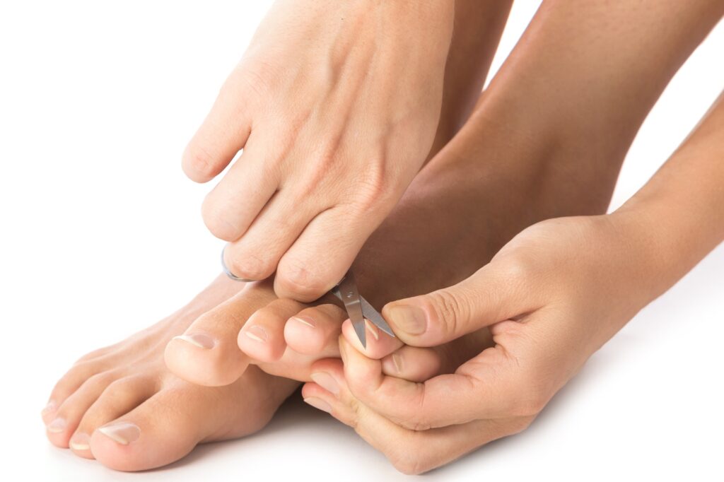 Closeup of Female feet and nail scissors